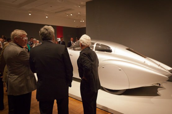 Jay Leno and Guest Curator Ken Gross look at the cars in the Allure of the Automobile. Photographer: