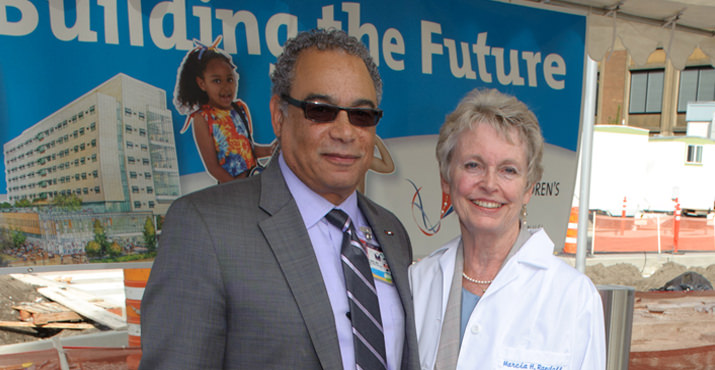 George Brown, M.D., FACP, Legacy Health president and chief executive officer and Marcia H. Randall, with her newly presented white coat embroidered with the new name of the new home: Randall Children’s Hospital at Legacy Emanuel.