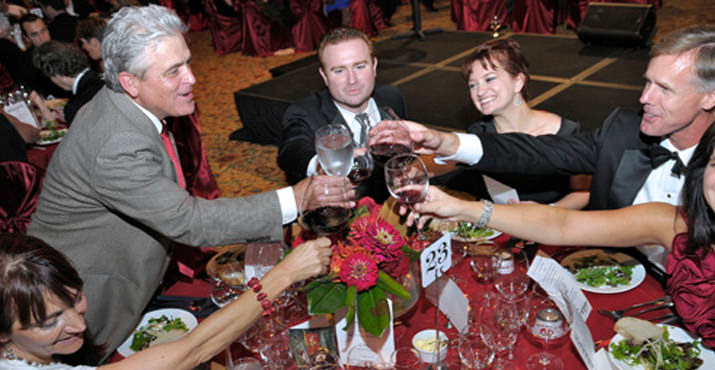 Ken Wright toasting with guests