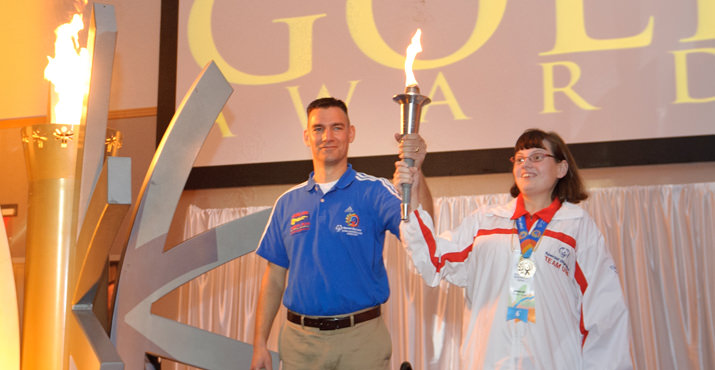 Special Olympics Oregon Board Member and (Law Enforcement Torch Run) LETR partner Joel Goodwin and Special Olympics Oregon World Game Athlete, Jillian Smalley light the Torch of Hope for the 2012 Governors Gold Awards.