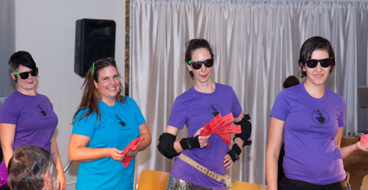 Rose City Rollers selling raffle tickets and sporting sunglasses from the sponsor, Groupon