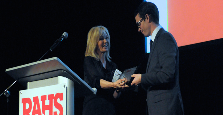 Julietta Bauman presenting an award to Nicholas Ehlen