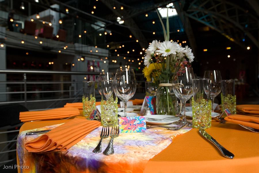 The Armory's Mezzanine is transformed into a scene straight from the production "One Night With Janis Joplin" with tie-dye place mats and flower center pieces