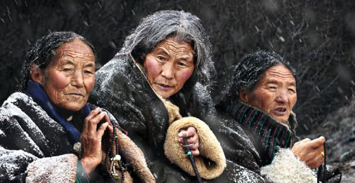 Photo of the Year 2011 was taken by Chan Kwok Hung, Hong Kong, China. It's Titled, "Pray". Location: Gansu Province of China, Tibetan ladies waiting for the Budda festival outside of temple.