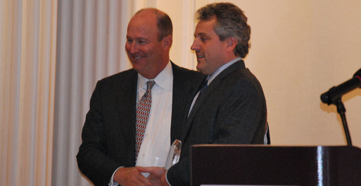 Roger Hinshaw, President of Bank of America Oregon, congratulates David W. Robinson, Ph.D. from OHSU. Oregon Health and Science University won the Corporate Volunteer Award.