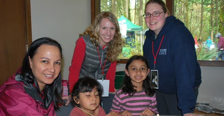 Melarie DeSelvia with her daughters Malia and Piriya get help from Derek Mellinger and Laura Markel