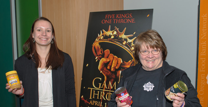 Representatives from the Oregon Food Bank accept donations from Game of Thrones fans.