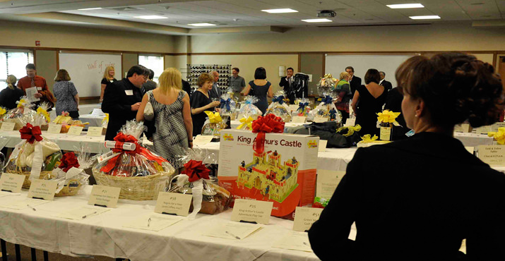 NCEF Board Member and Auction Chair Christina Pearl surveys the silent auction.