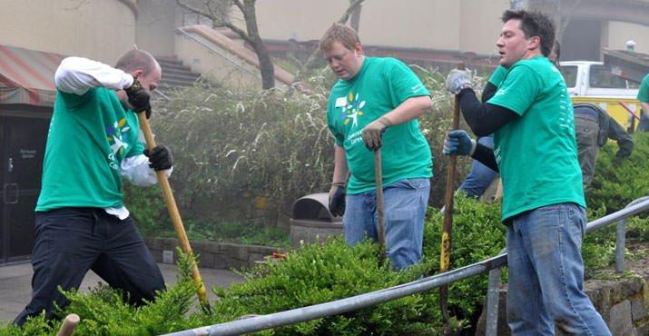 Comcast employees Stephane Roux, John Gawthrop and Matt Heavener dig in at the Oregon Zoo. Photo by Chelsi White.