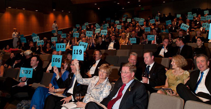 Guests at the Live Auction hold up their bid cards during the Special Appeal.