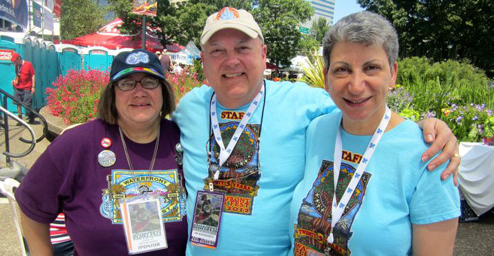 Lucinda Tate, who is on the Oregon Food Bank Board of Directors, Jim Wadsworth, and Janeen Wadsworth, the CEO/Chief Operating Officer smile and enjoy the omelets in the Sponsor's Tent.