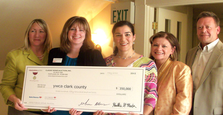 The donation to YWCA Clark County from the Classic Wines Auction (CWA) is proudly displayed by: Paul Vogel, CWA Board Member (Pacific Power); DJ Wilson, CWA Board Member (KGW Media Group); Heather Martin, CWA Executive Director; Sherri Bennet, YWCA Clark County Executive Director; and Kelly Walsh, YWCA Clark County Board President (Schwabe Williamson & Wyatt) (pictured from right to left).