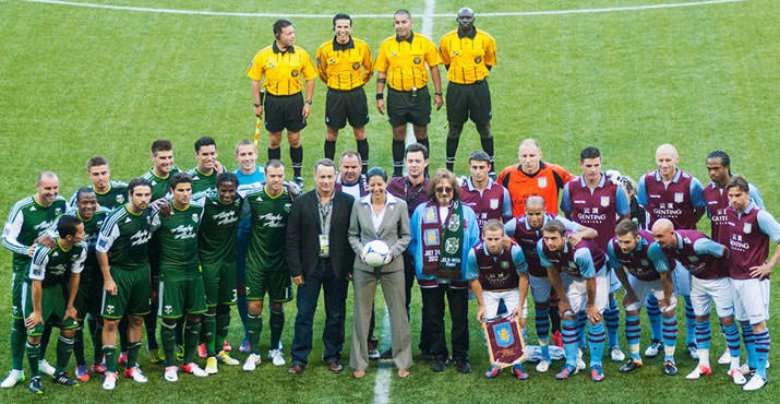 The gracious star posed with the Timbers and their opponents, Aston Villa.