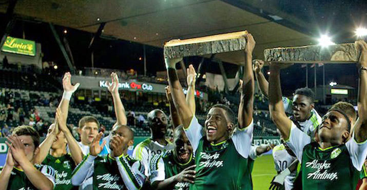 The Timbers hold up log slabs after the game with Aston Villa