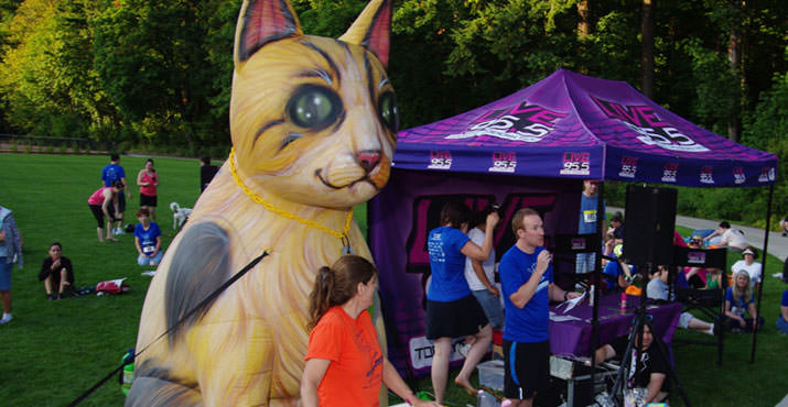 Closing ceremonies included raffle prizes and awards for fastest finishers - all done in front of the big cat (in orange - Kathy Covey, Race Director; in blue - Aaron Asmus, CAT Executive Director)