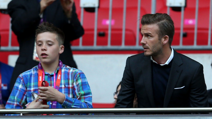 Footballer David Beckham watches with his son Brooklyn during the men's Football first round group A match between Great Britain and United Arab Emirates on Day 2 of the London 2012 Olympic Games at Wembley Stadium.