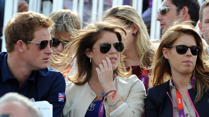 Prince Harry, Princess Eugenie, and Princess Beatrice watch the Eventing Cross Country Equestrian on Day 3 of the London 2012 Olympic Games at Greenwich Park