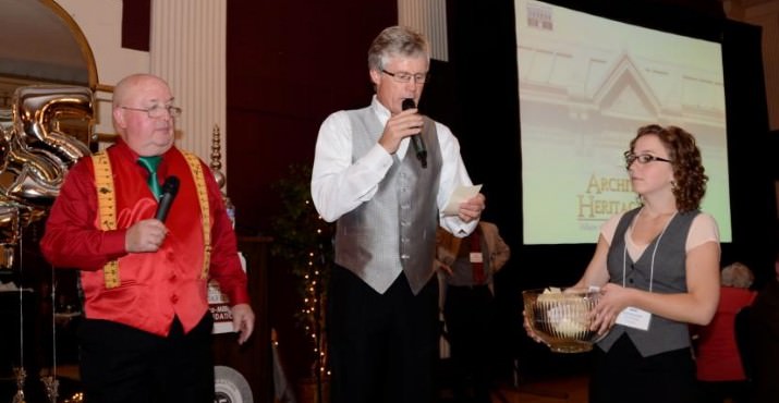 Master of Ceremonies, "Handyman Bob" Strong; Auctioneer, Chris Sheik; and Volunteer, Stephanie Downer. This photo is a raffle drawing.