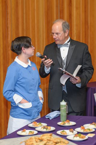 Laura Rhoman from Slappy Cakes talking to the auctioneer, Graham Crow