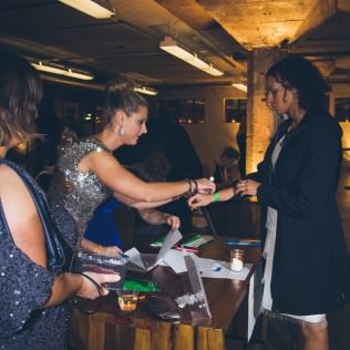 Board member Courtney Francis Campbell and committee member Ali Murphy check in guests at Levé’s Ninth Annual Charity Ball.