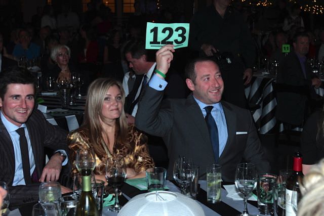 Shawn Menashe raises his auction number to support the PAST&E