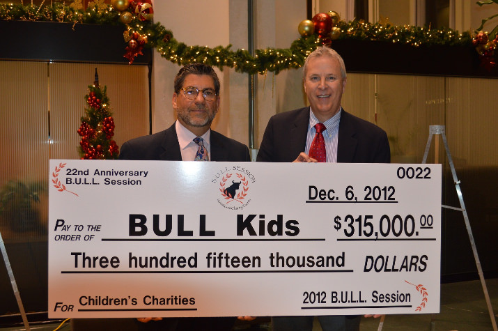 Tim Gauthier & Frank Wall, B.U.L.L. Board of Directors, present the total funds raised of $315,000 from the 2012 BULL Session Invitational Charity Events.