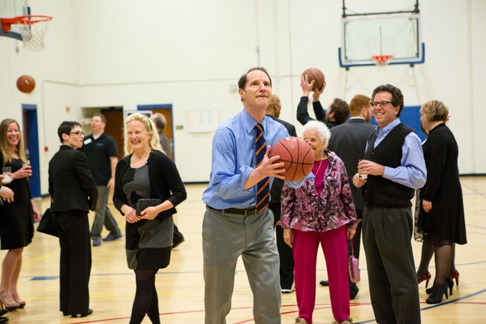 Senator Ron Wyden contemplates his first basketball shot of the night as a crowd begins to gather at the MJCC Friends of the Center Dinner