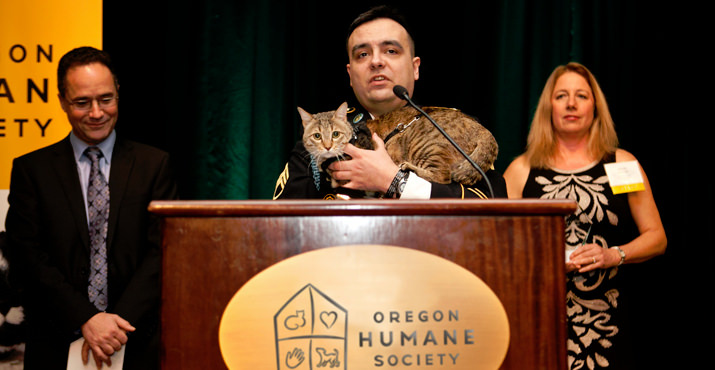 From left emcee Matt Zaffino with Diamond Collar Hero Winner Sgt. Jesse Knott and his cat Koshka the he rescued from Afghanistan with OHS Executive Director Sharon Harmon cheering him on.