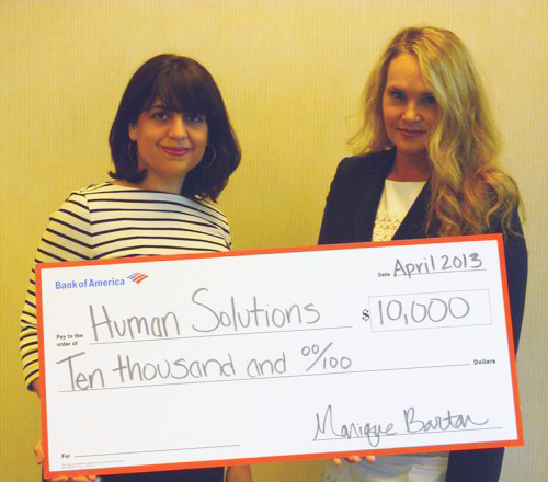 Nicole Frisch, assistant Vice President, present Human Solutions received the grant check from Monique Barton, Senior Vice President of Corporate Social Responsibility at Bank of America