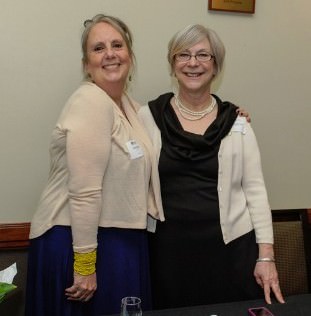 Carol Graven and Claudia Krueger, Central City Concern staff, sold raffle tickets for chance to win signed Blazer ball and tickets to a game next season. Proceeds from raffle will help children in our housing attend summer HOOPS camp.