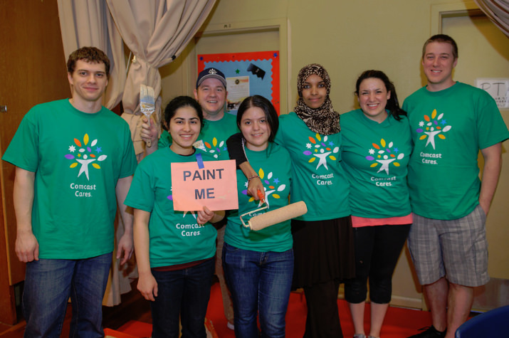 Girls Inc. of NW Oregon volunteers join Cares Day at Faubion School for some painting. Pictured: Zane Grout, Connor Music (in the back), Sadaf Assadi, Florisela Herrejon, Fardowsa Idris, Lauren Munoz-Tremblay and Rob Bush. Photo by Andie Petkus.