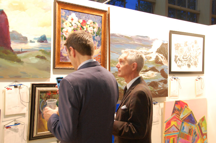 Onlookers bid in silent auction on some 240 or so donated works of art in the Grand Event