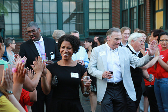 Board members Andrae Brown and Allyson Harris, supporter Greg Goodwin, Kuni Automotive, State Treasurer Ted Wheeler, and board member Ken Thrasher make their way through the high-five tunnel into the tent for the live program.