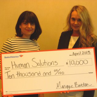 Monique Barton, right, Senior Vice President of Corporate Social Responsibility at Bank of America, and Nicole Frisch, assistant Vice President, present Human Solutions with a grant check.   