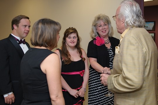 Host Howard Hedinger greets guests and performer Tim Whiting along with Edwards Center Executive Director Jessica Leitner.