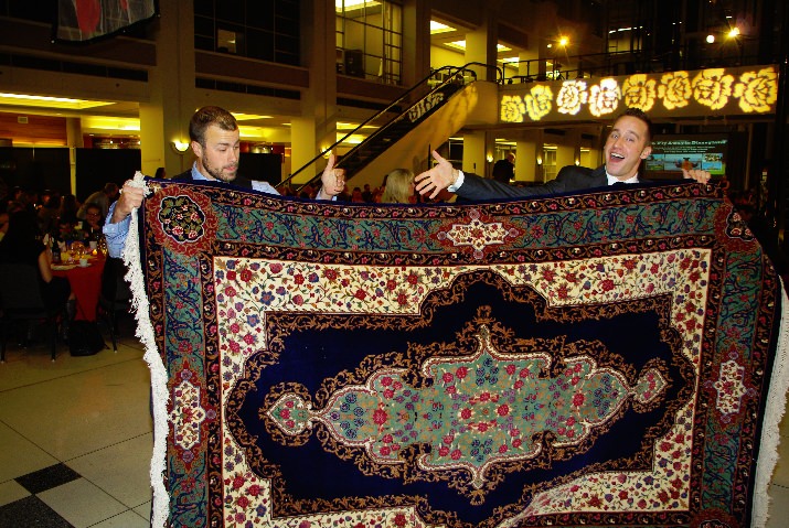 Levi Kropf and Jeff Deering model a classic rug from Atiyeh Brothers 