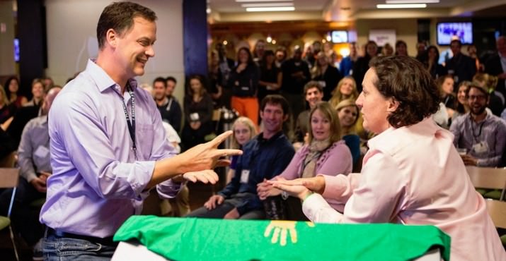 John Eggers and Colleen Finn duel it out with Rock, Paper, Scissors to determine our raffle winner.