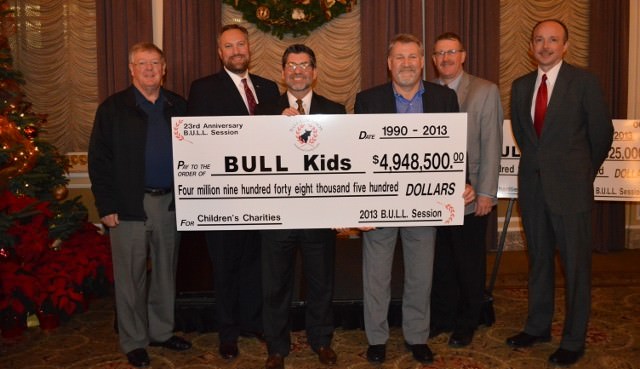 BULL Session board members pose with check for $4.9 million, the total amount donated in past 23 years: Jim Moss, Jason Kaufman, Tim Gauthier, Ross Vroman, John Mohlis, Dave Johnston