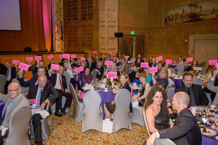 Bidders during the paddle raise auction in the Kridel Ballroom