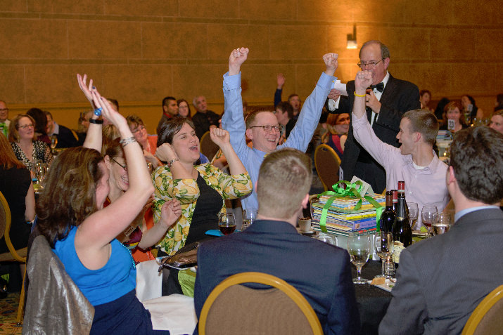 Table mates celebrate winning the Book Pack Frenzy, which pits tables against one another to purchase the most book packs for SMART students.  