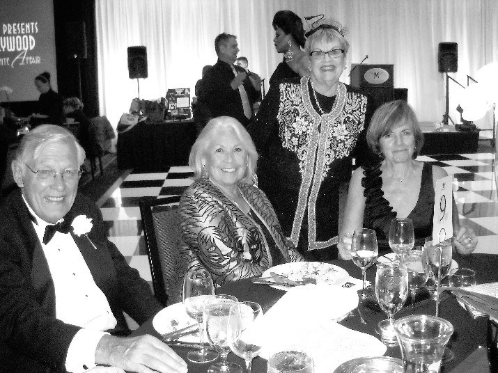 Hank and Margie Grootendorst, Carol Bray, Gala Chairman; Jean Armstrong, Advisory Board and in the background Poison Waters, emcee of the event.