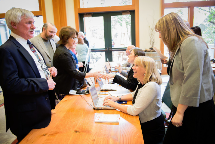 Doug Plambeck, CPAH Board Treasurer, and other CPAH supporters register with Event Savvy staff and Chase volunteers at HomeWord Bound.