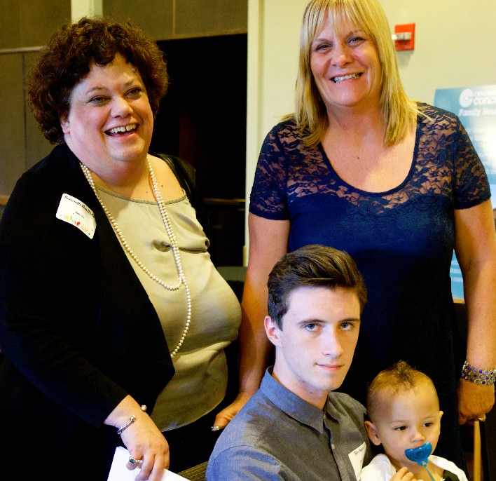 Honorable Nan Waller, Presiding Judge for Multnomah County, Tyler Snyder holding Kaden Patterson, and CCC’s Family Housing Program Manager Holly Redeau.