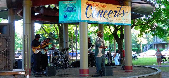 An outdoor concert at Dawson Park draws music lovers. 