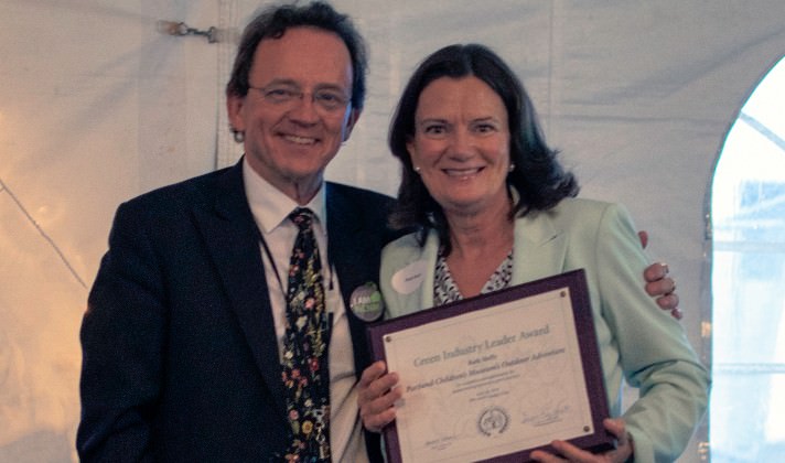 NCNM President David J. Schleich with Ruth Shelly, executive director of Portland Children’s Museum*, who accepts an NCNM Green Industry Leadership Award for the museum’s newest permanent exhibit, Outdoor Adventure, which helps children experience nature at its best.