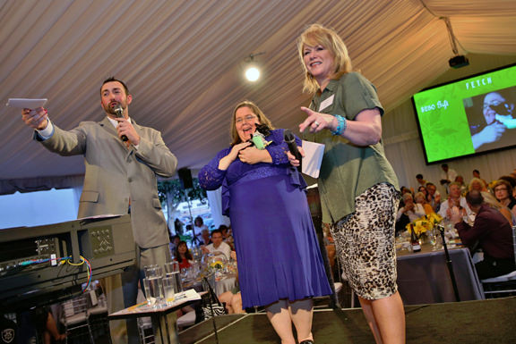 Auctioneer Justin Timm, OHS Investigator Wendy Reimer and KATUs Helen Raptis raising money to help the pets of OHS