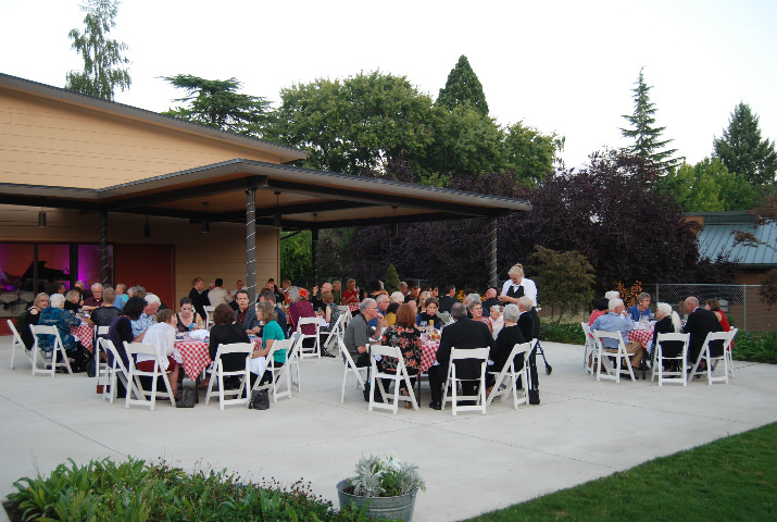 Over 80 guests enjoy pasta and wine on Edwards Center’s lovely garden patio.