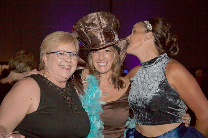 Dr. Janice Olson, MD, MHA, Medical Director, Children's Cancer and Blood Disorders Program, Randall Children’s Hospital at Legacy Emanuel, Regina Ellis, CCA Founder and CEO, and CCA Board Member, Andrea Corradini, Senior Merchandising Director, Emerging Markets Running, Nike, Inc., get into the spirit of the playful night.