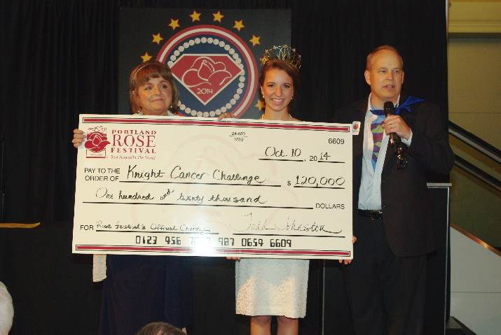 Cancer Survivor *Monique Eska accepts donation check from Queen *Emma Waibel and Rose Festival Foundation President *Todd Johnston.