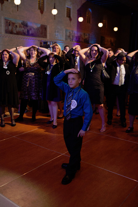 Wish child Cason Vandehey, 10, leading attendees in a game of heads or tails.